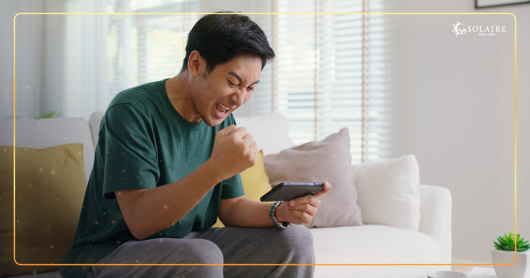 A Man Happily Celebrates After Winning in an Evolution Play Online Casino eGames | Solaire Online