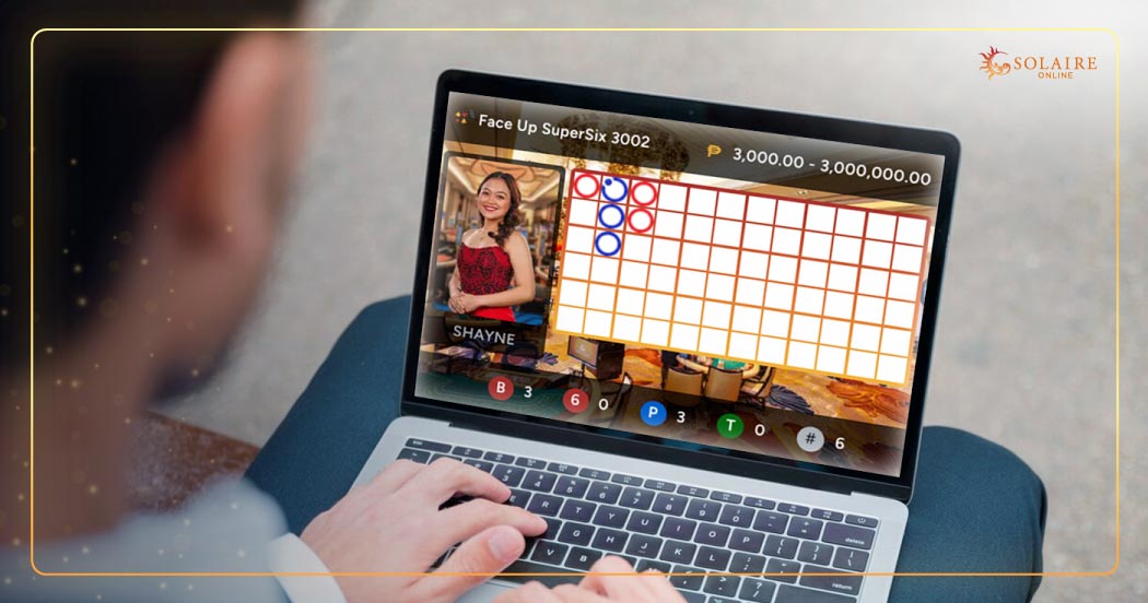  Baccarat Tips - A Man Playing Baccarat Online On His Laptop