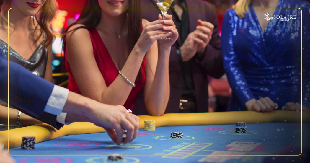 How To Play Baccarat - A Group Of People Playing Inside A Casino