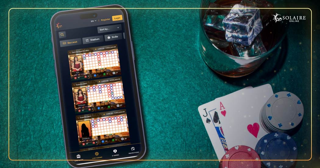 Play Casino Games Online - A Mobile Phone, Pair of Cards, and Poker Chips